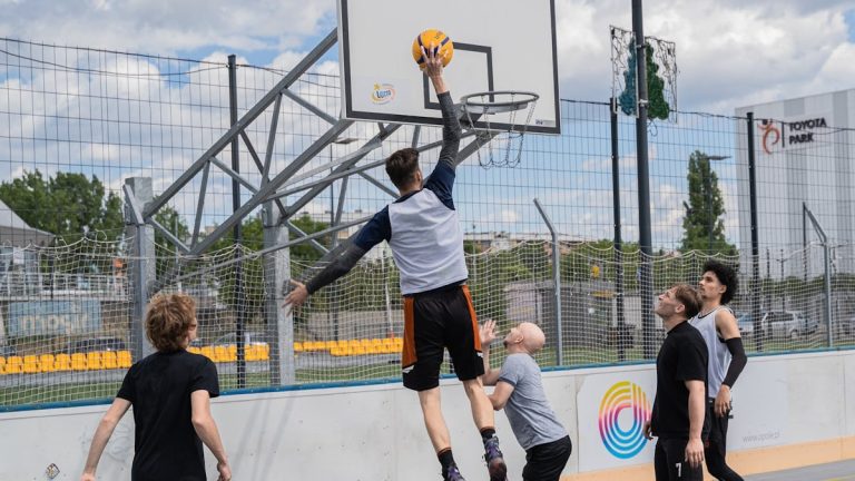 Basketball player jumps to shoot a basket.