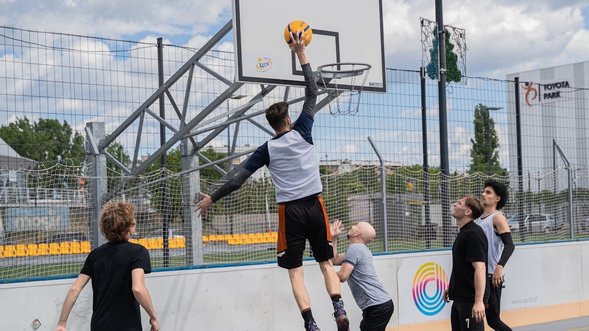 Basketball player jumps to shoot a basket.